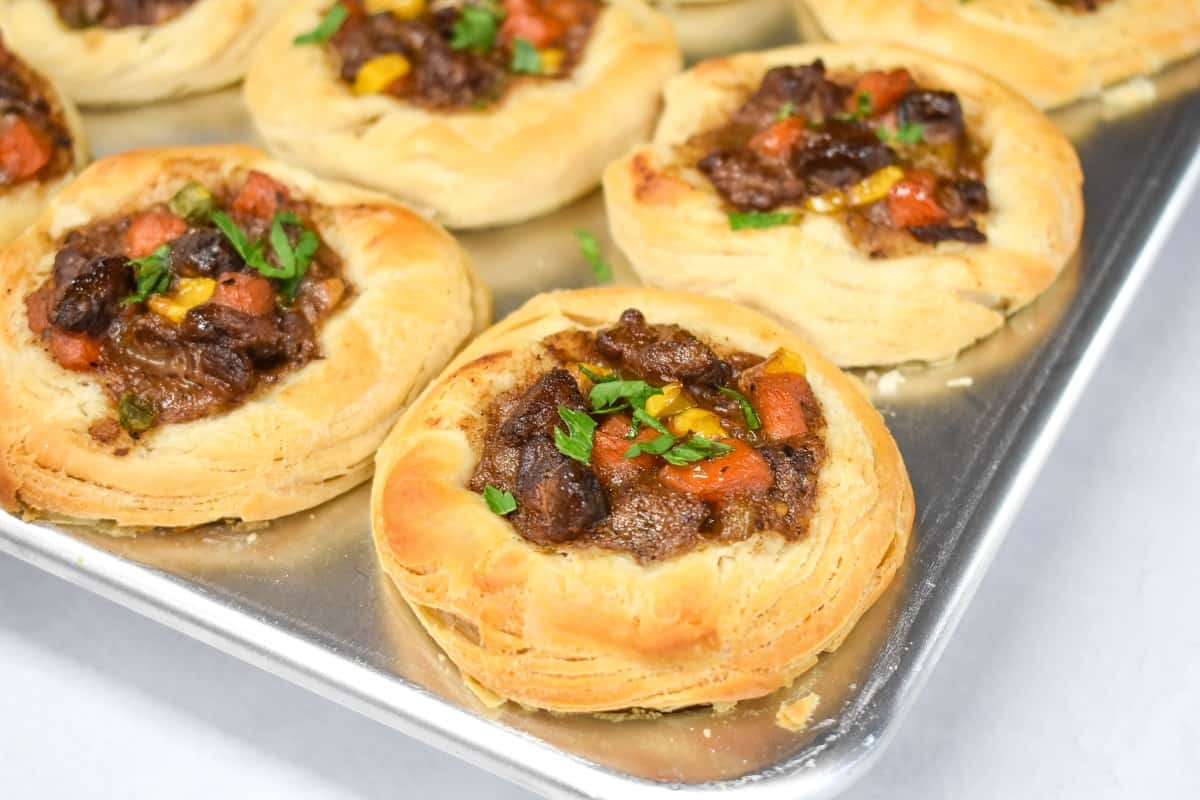 A close up of the mini pot pies still in the muffin tin.