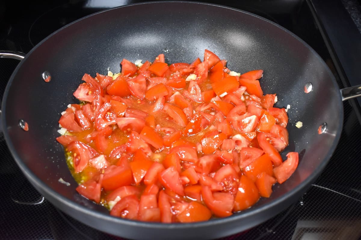 Chopped tomatoes in a large, non-stick skillet.