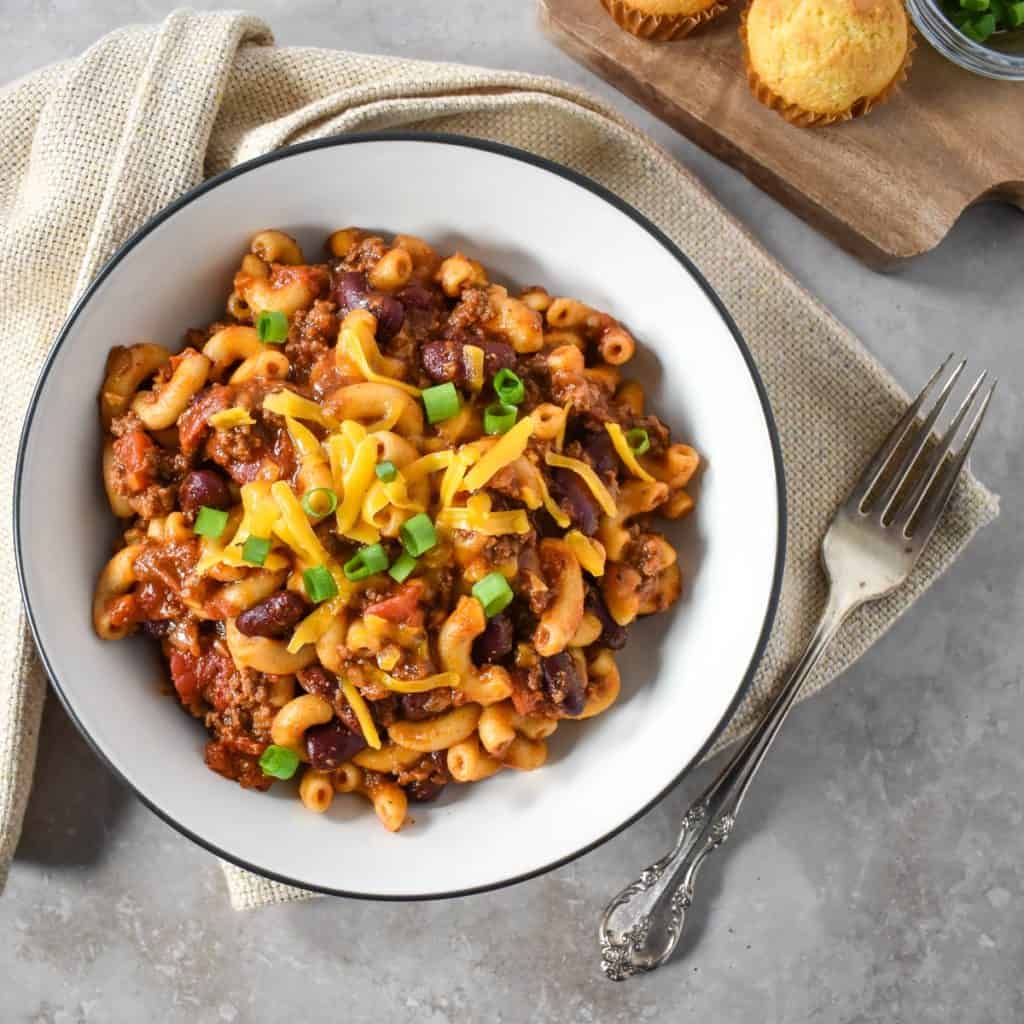 The finished easy chili mac served in a white bowl with a black rim.