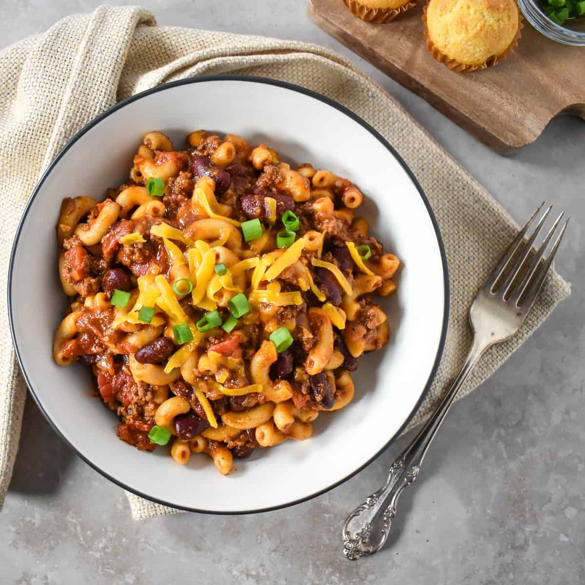 The finished easy chili mac served in a white bowl with a black rim.