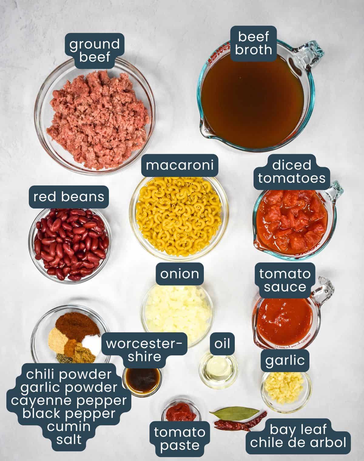 The ingredients for the chili mac prepped and arranged on a table, with each one labeled.