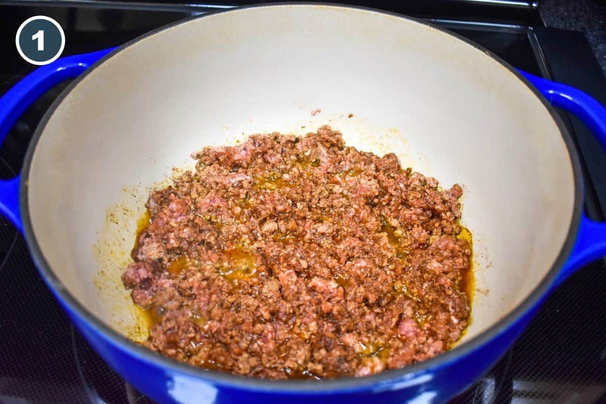 Ground beef seasoned and browning in a large Dutch oven.