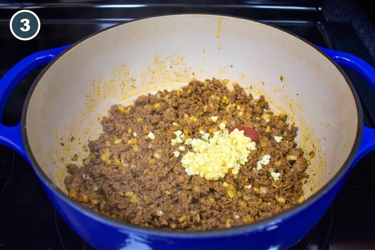 Minced garlic and tomato paste added to the ground beef and onions.