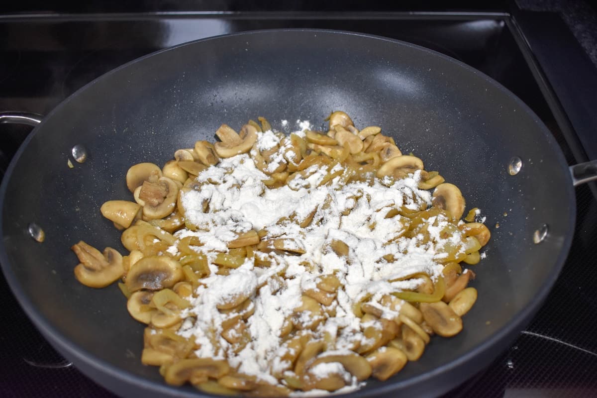 Flour sprinkled over the onion and mushroom mixture.