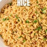 A close-up of the seasoned rice in a white serving bowl with a white graphic on the top with the title.