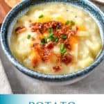 A close up of the finished potato soup served in a white bowl with a blue rim with bread slices and a another soup visible in the background and a teal and white graphic with the title in teal letters.