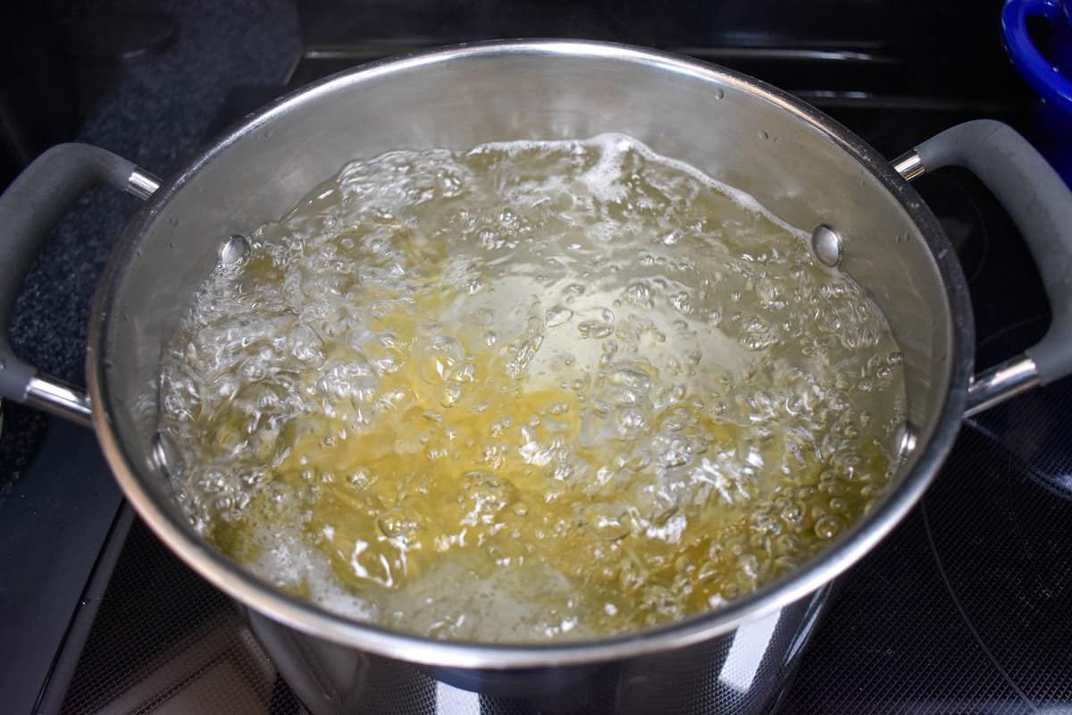 Pasta cooking in a large pot with boiling water.