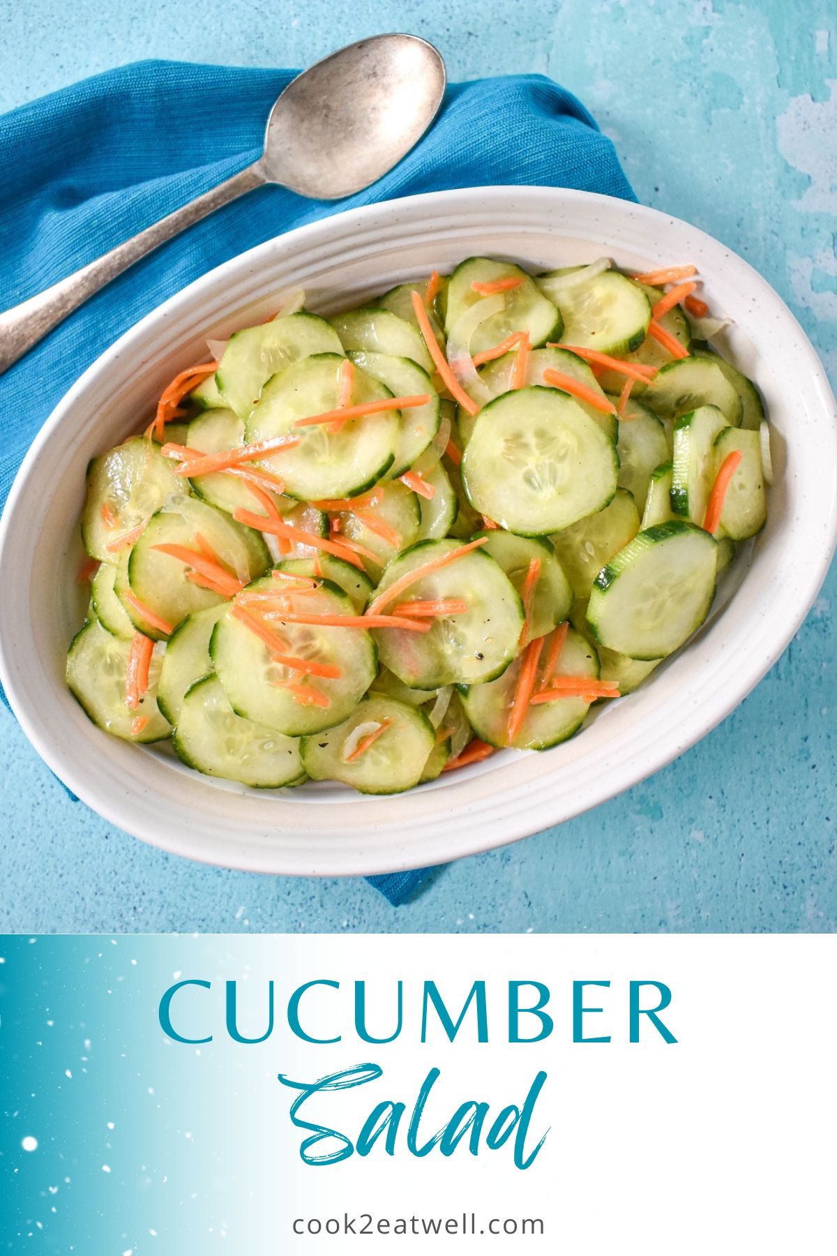 The cucumber salad served in a white bowl with a teal and white graphic underneath.