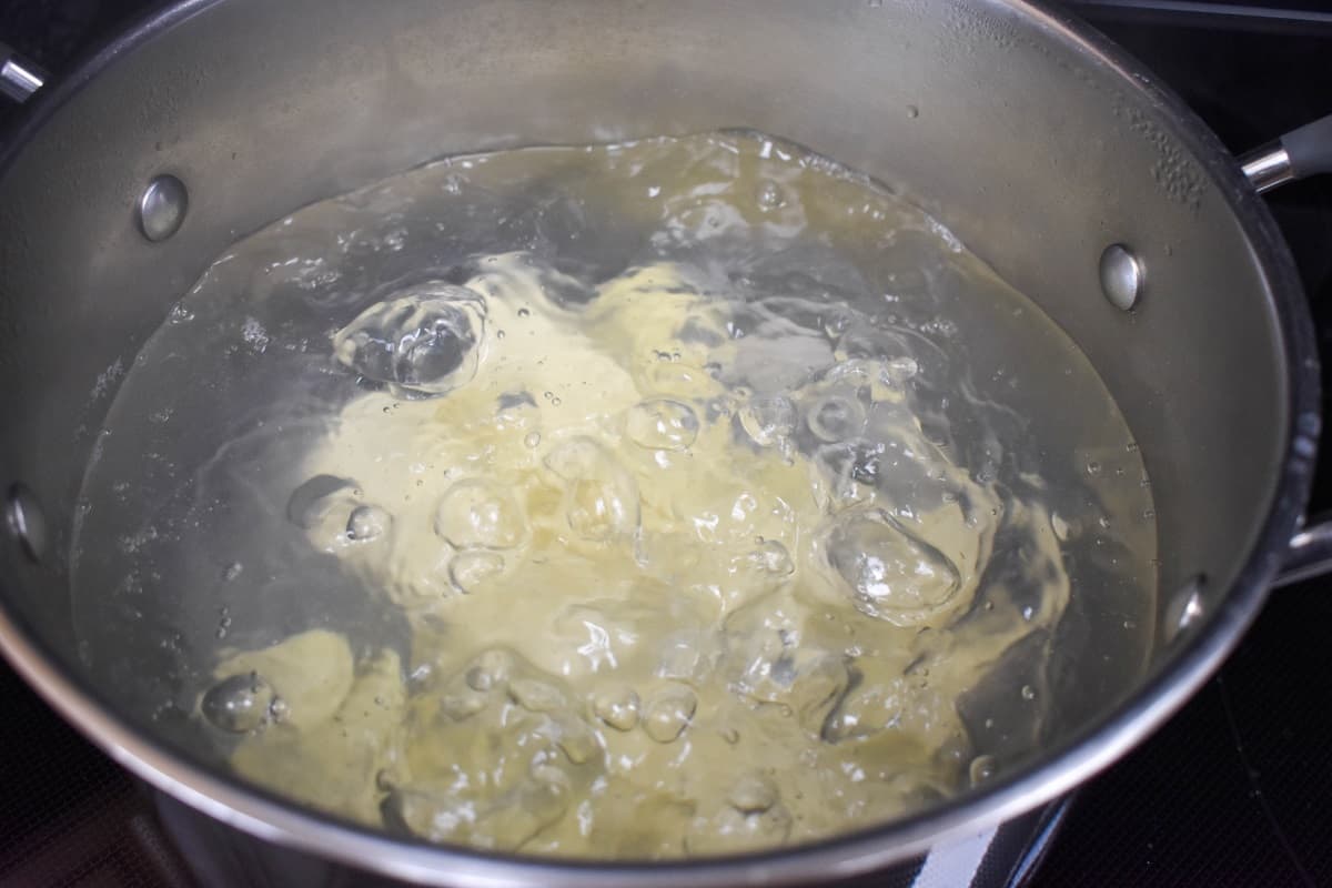 Yuca boiling in a large pot.