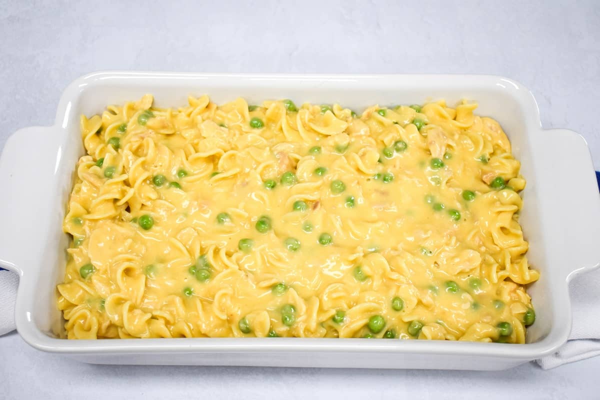 The prepared mixture in a white baking dish set on a white table.