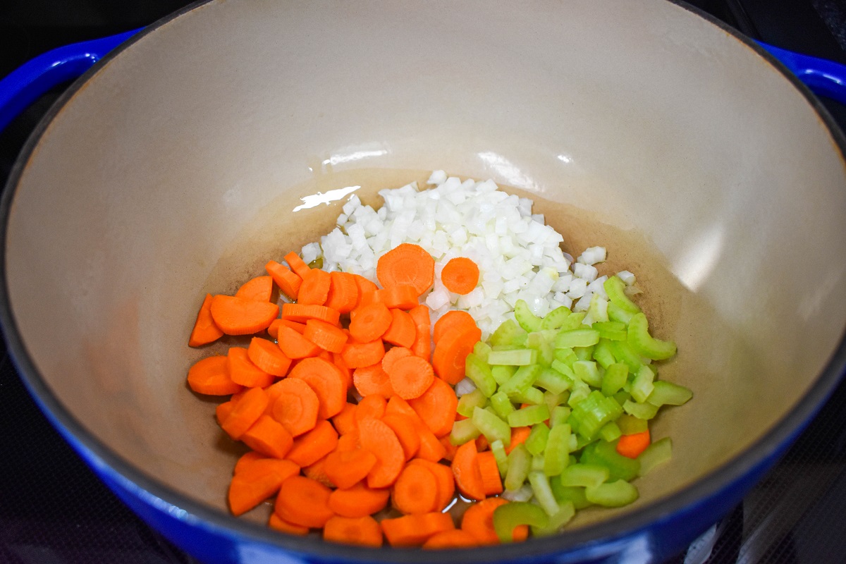 Diced carrots, celery, and onions in a large pot.