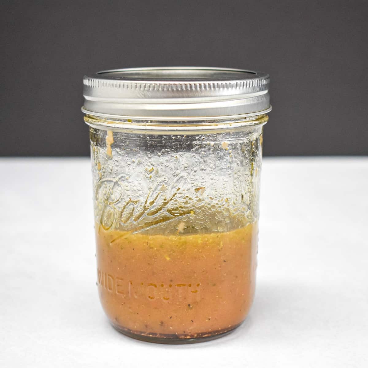 Homemade Italian dressing in a canning jar.