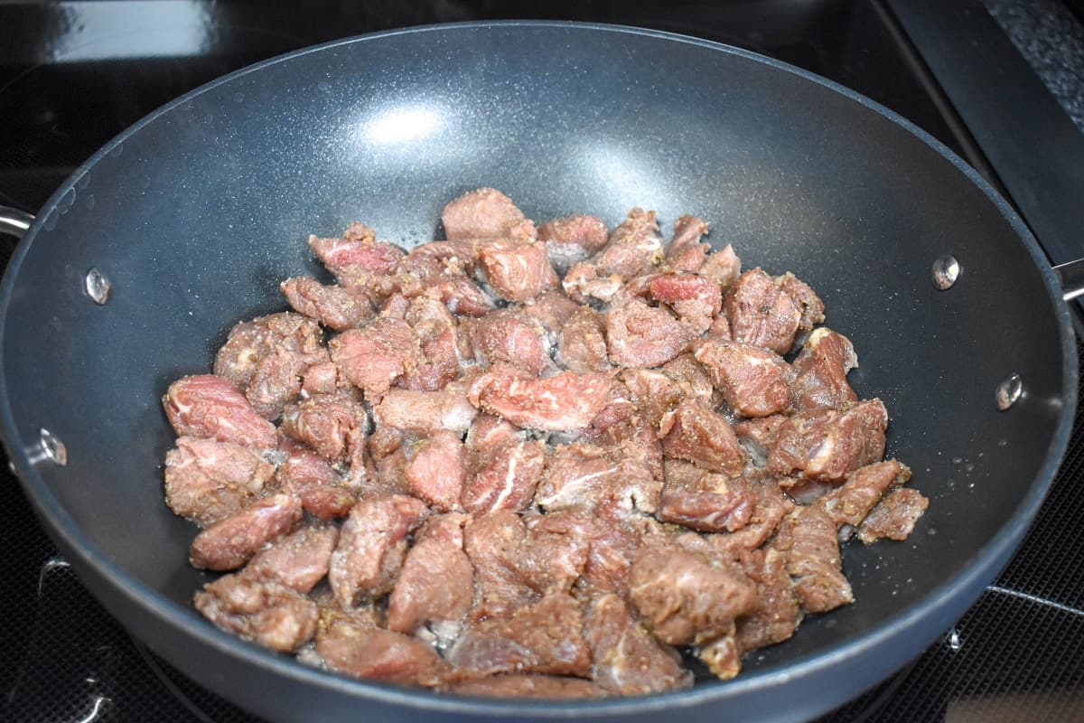 Steak tips in a large, non-stick skillet before browning.