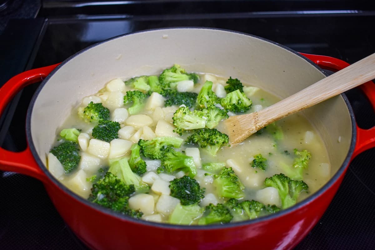 The final step of making the soup with the tender potatoes and the broccoli cooked still in the pot.