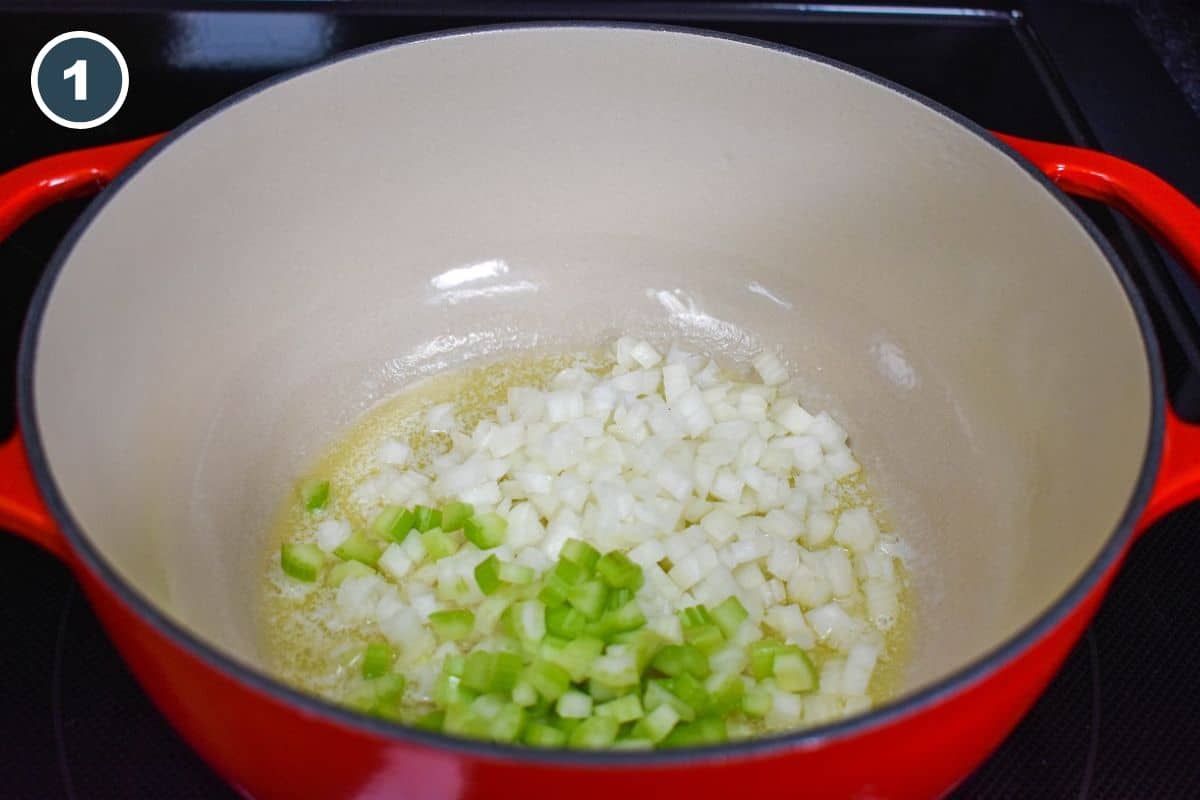 Sautéing diced onions and celery in melted butter in a red Dutch oven.