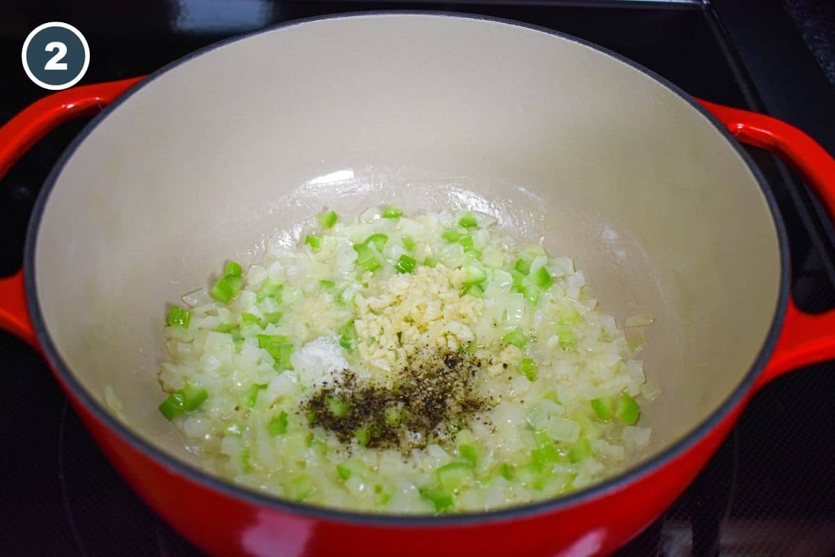 Adding minced garlic, salt, and black pepper to the cooked onions and celery.