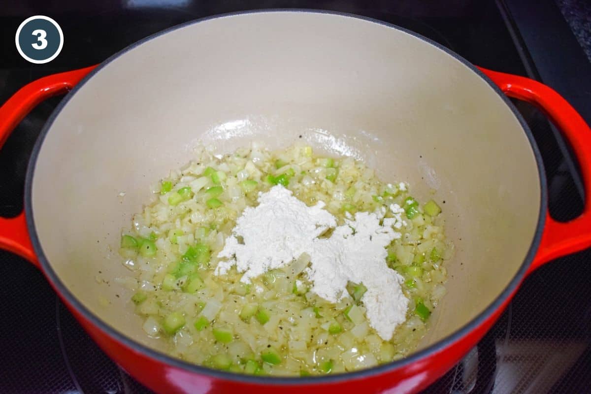 Stirring all-purpose flour into the vegetable mixture to make a roux.