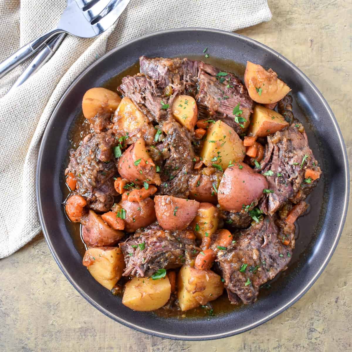 The french onion pot roast served on a large gray platter.