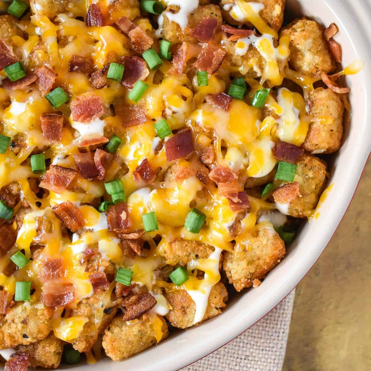 The finished tater tots casserole garnished with green onions.