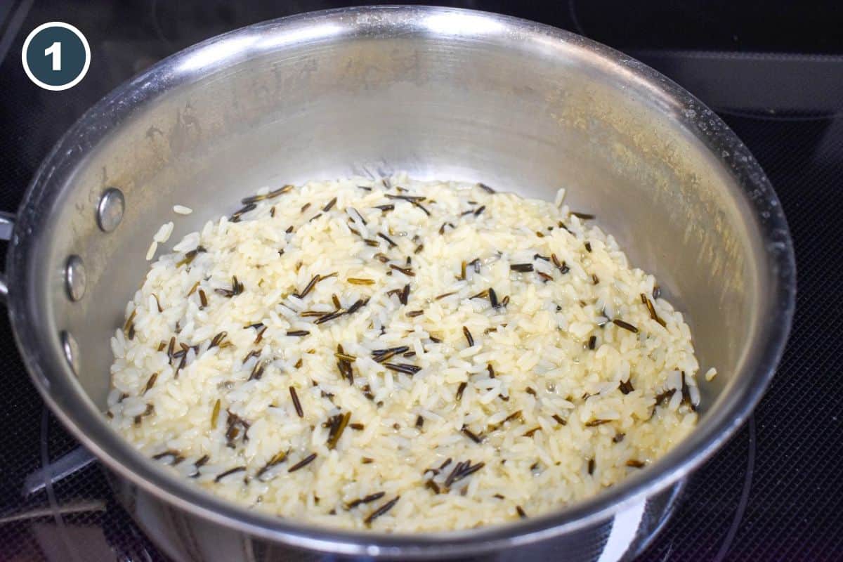 Cooked wild rice and long grain rice in a saucepan on the stove.