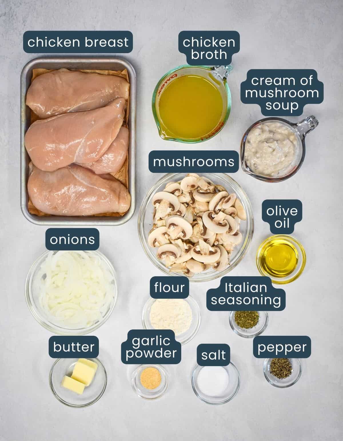 The ingredients for the chicken with cream of mushrooms soup prepped and arranged on a white table with each labeled with the title.