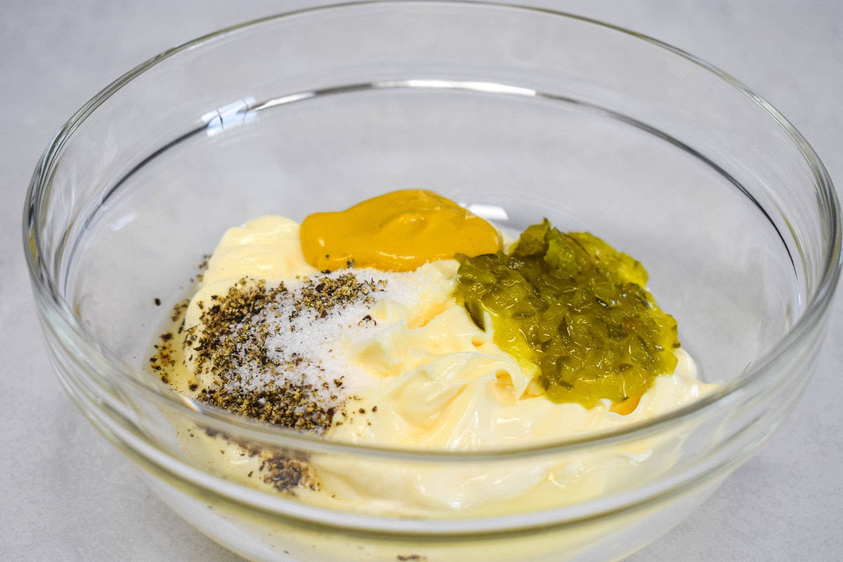 The ingredients for the dressing in a glass bowl, before mixing.