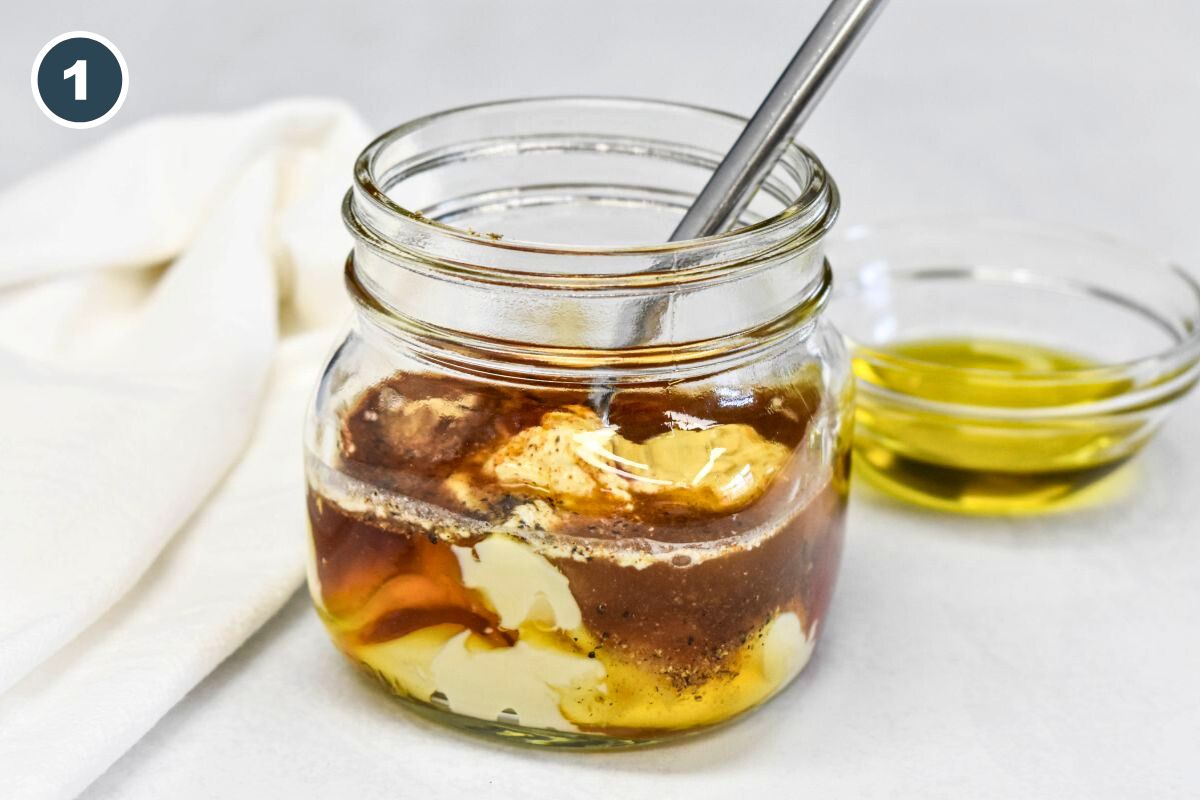 Mayonnaise, ketchup, vinegar, and seasonings layered in a glass jar before mixing.