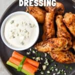 Pinterest graphic showing buffalo wings with dressing, with text that reads “Homemade Blue Cheese Dressing.”