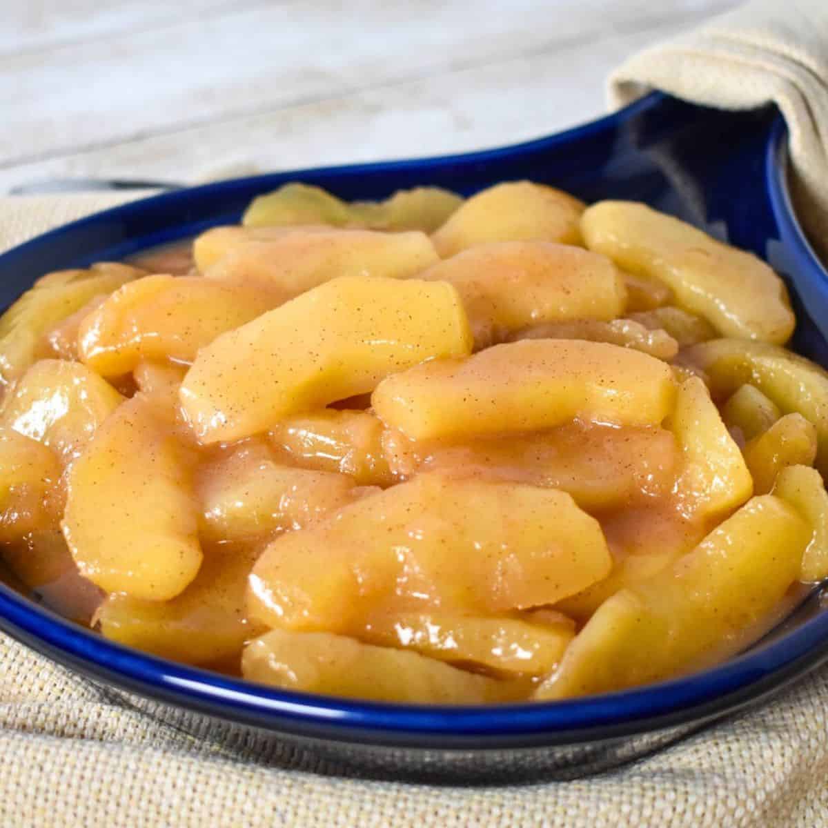 Cinnamon Apples served in a blue stoneware skillet.