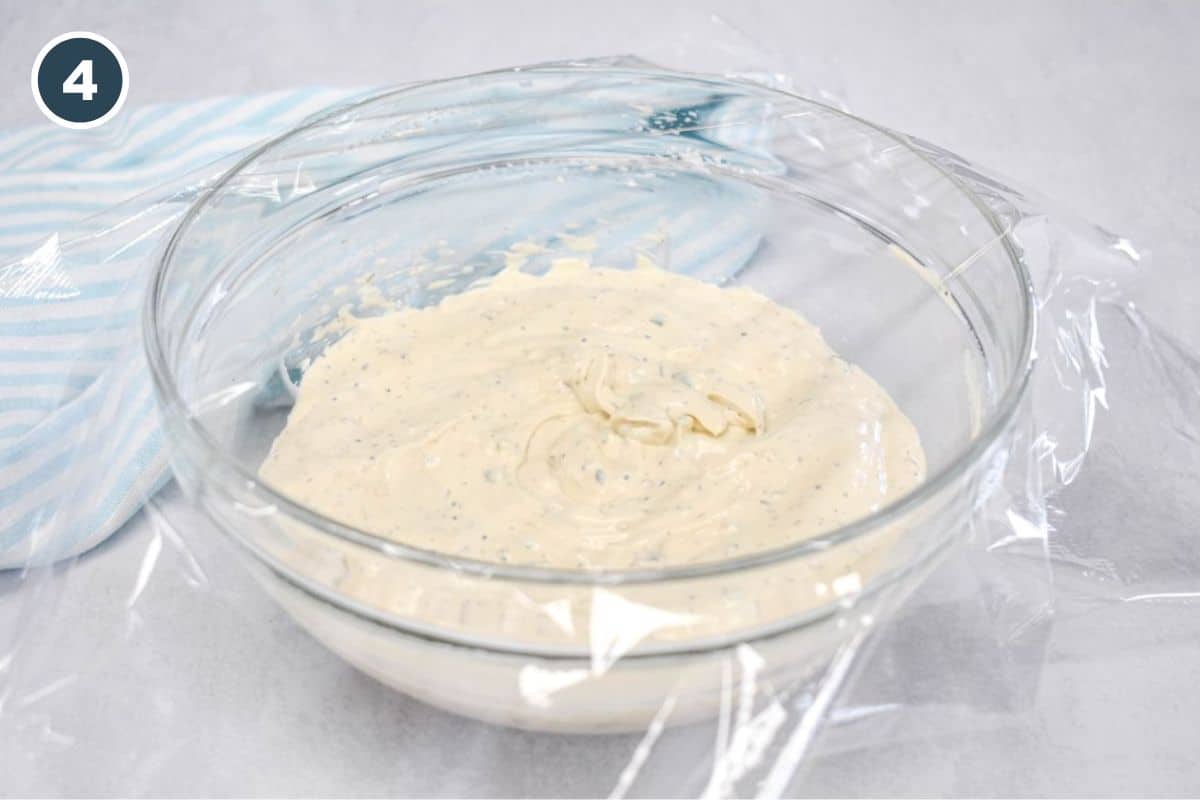 Finished dip covered with plastic wrap and ready to chill before serving.