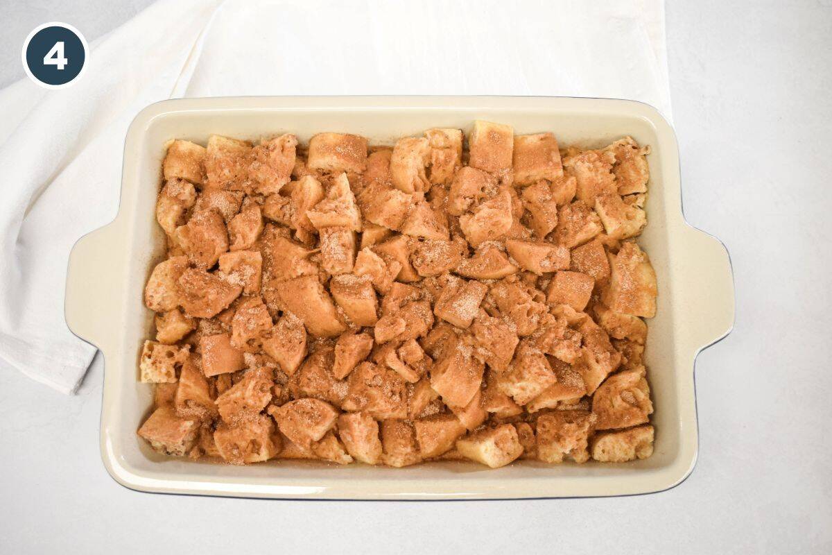 Topping the bread with a cinnamon sugar mixture before resting or baking.