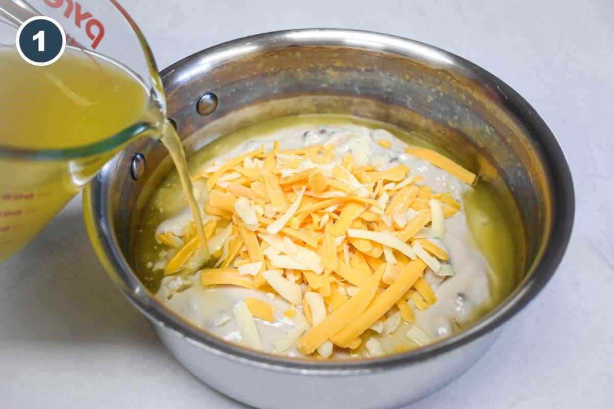 Chicken broth being poured into a saucepan filled with cream of mushroom soup and shredded cheese.