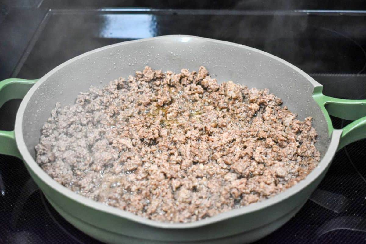 Fully browned ground beef in a skillet for ground beef bowls.
