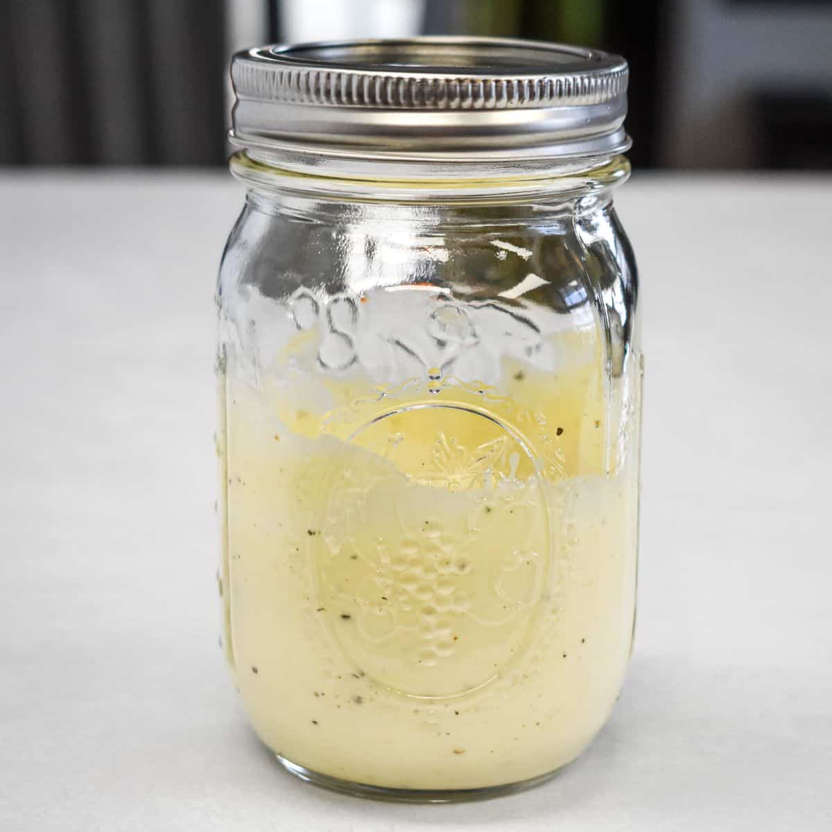 Garlic aioli mixed in a mason jar until smooth and creamy.