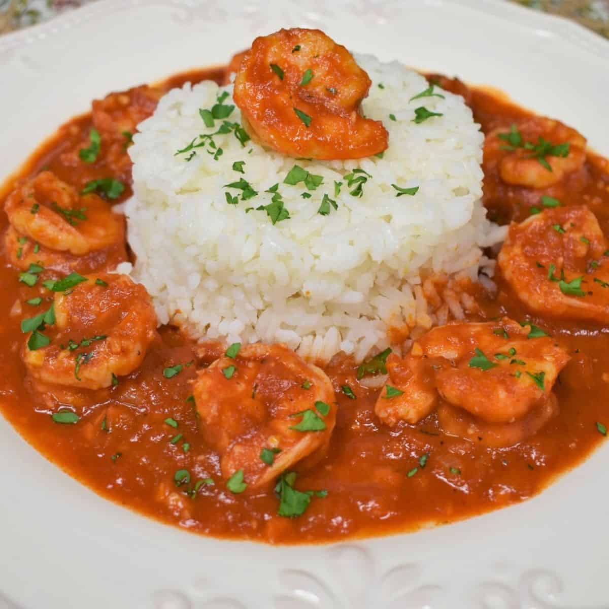 Camarones Enchilados served with white rice in a white plate.