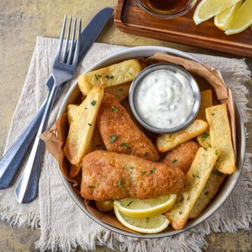 Homemade tartar sauce served with battered fish, French fries, and lemon wedges.