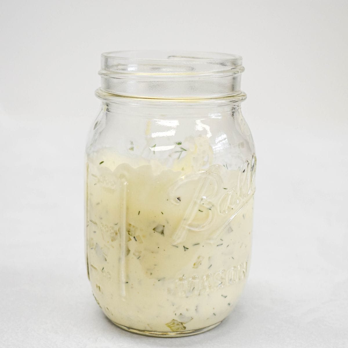 Tartar sauce mixed in a glass jar and ready to refrigerate.