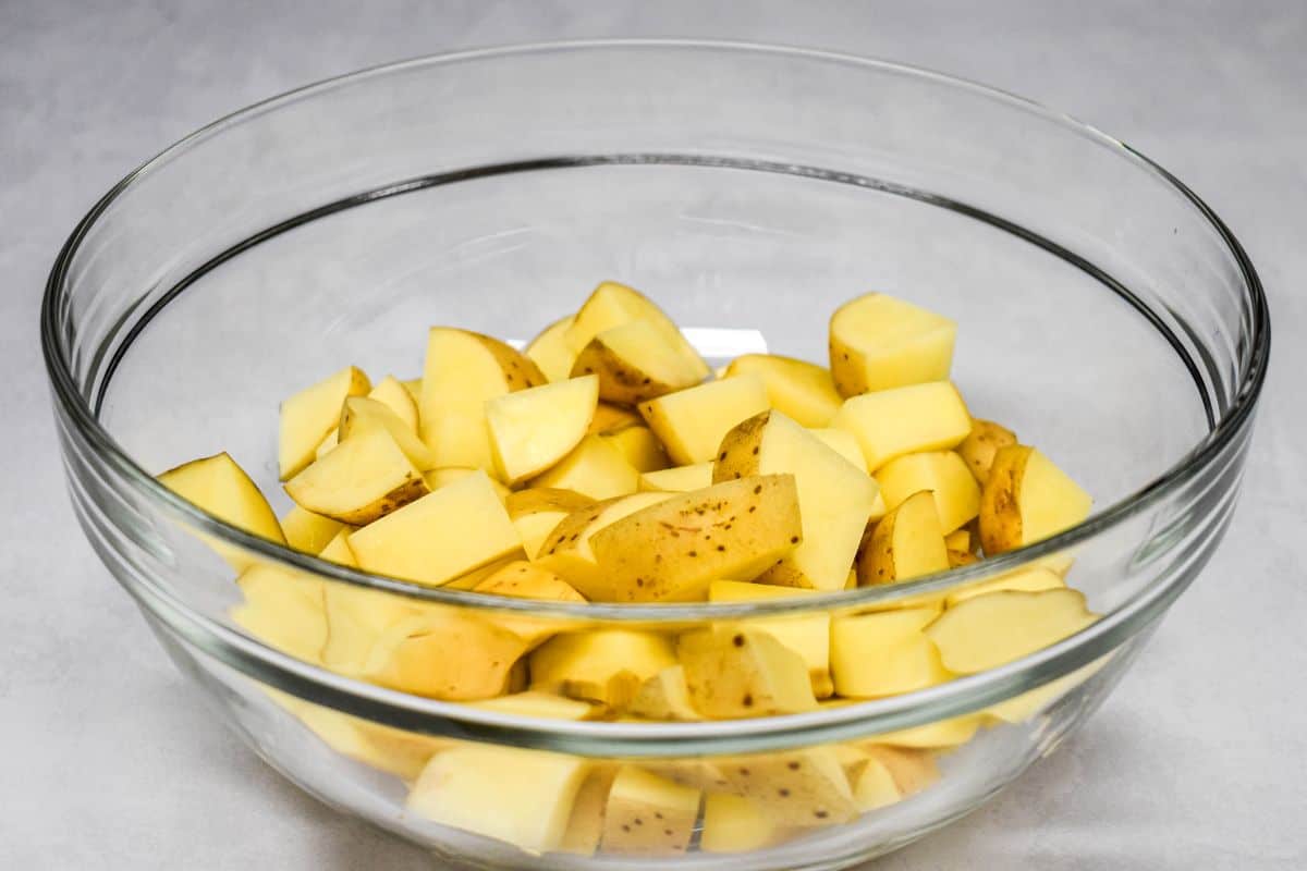 Cut gold potatoes in a glass bowl.