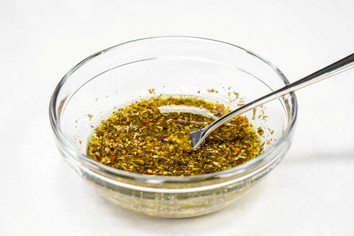 Olive oil and seasonings mixed in a small bowl.