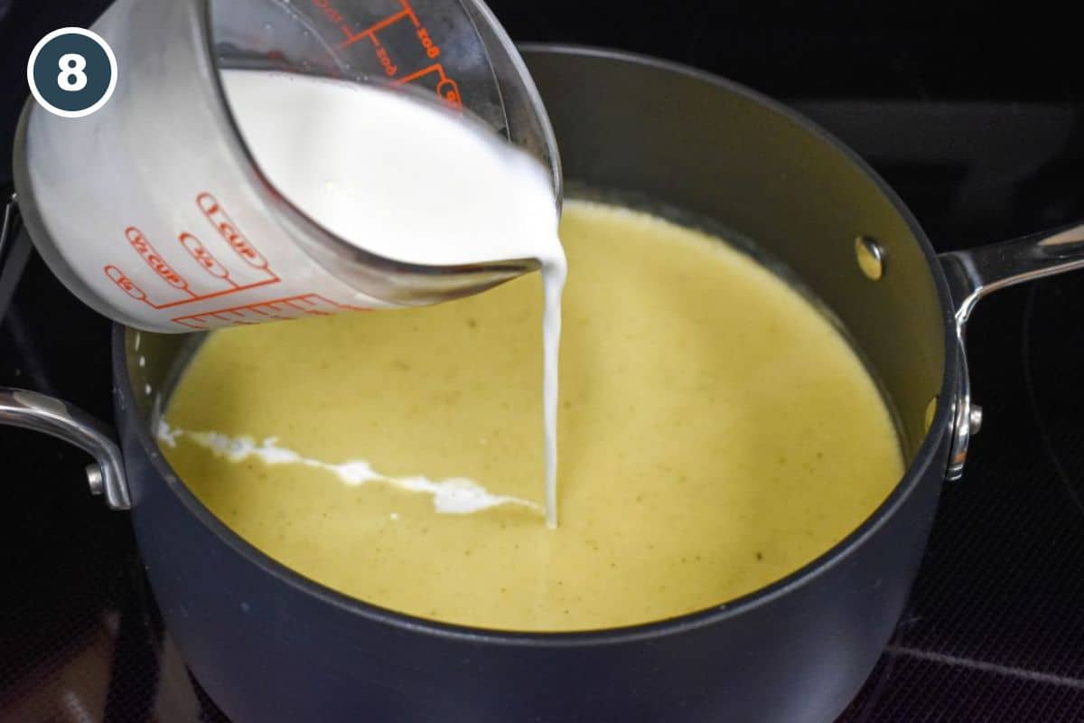 Half-and-half being poured into the blended celery soup.