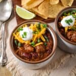 Steak chili topped with shredded cheddar cheese, sour cream, and green onions.