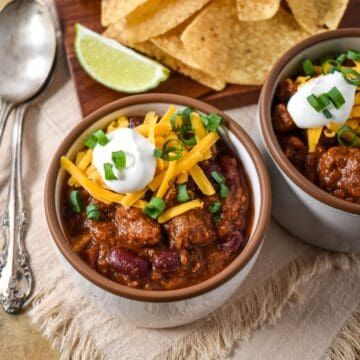 Steak chili topped with shredded cheddar cheese, sour cream, and green onions.