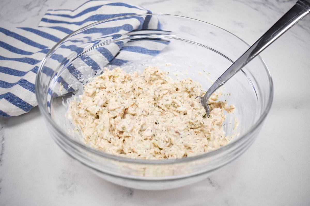 Canned salmon salad mixed with cream cheese, mayonnaise, celery, onion, lemon juice, dill, and black pepper.